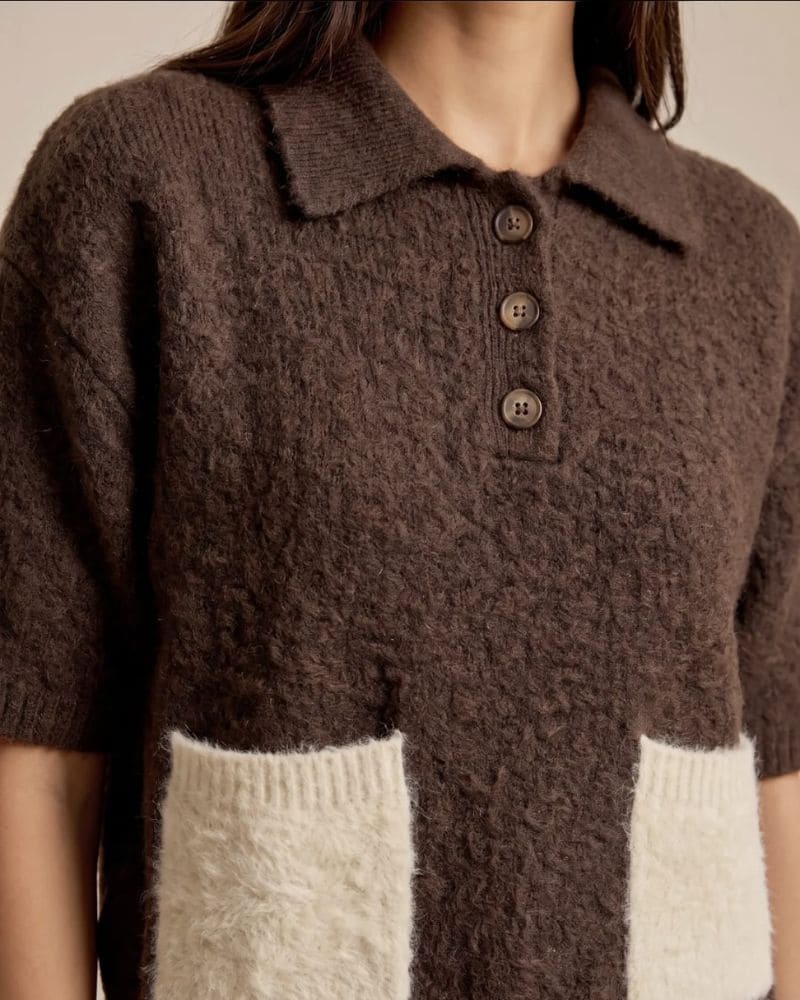 Sandy knitted top showing textured knit, polo collar and cream contrast panels