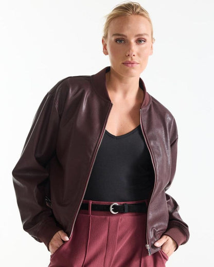 Model wearing the Bian wine red leather look bomber jacket open at the front